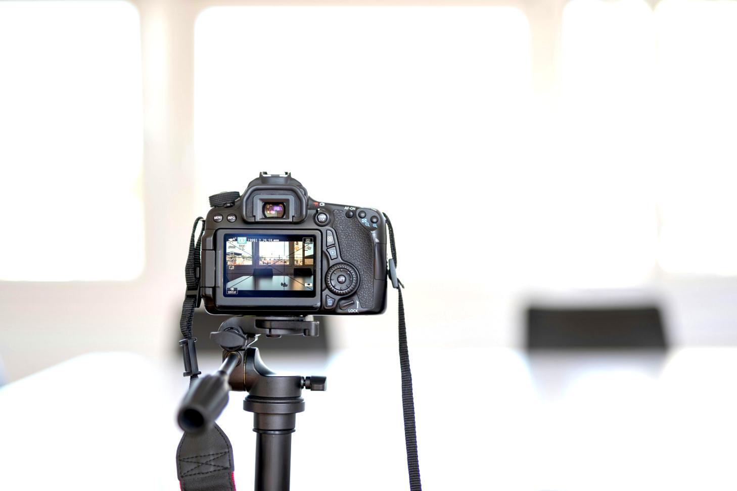 Student working on editing workstation with multiple monitors displaying timeline sequences