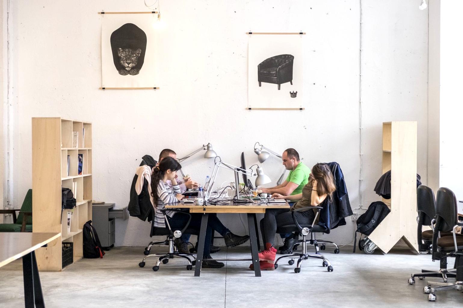 Student working on video editing project with instructor providing feedback